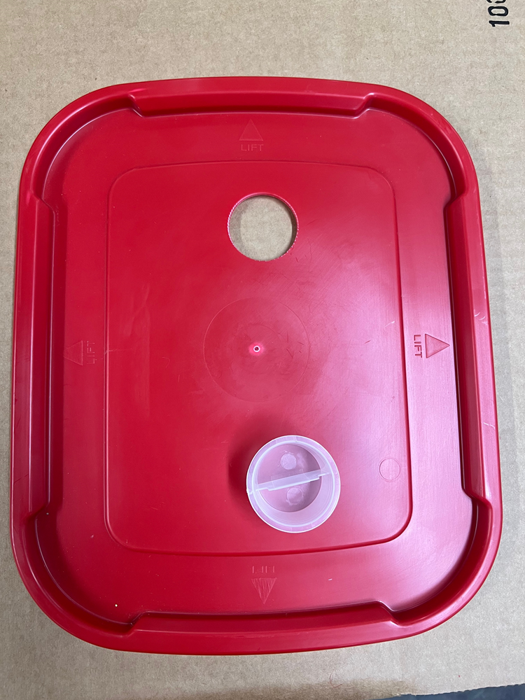 A red plastic Spare Parts for Buckets container with a lid on it by RentACoopUS.